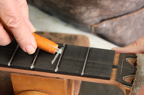 Bending tool for use with fret wire to set radius for fret board insertion.